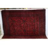 Eastern Woolen Red Ground Rug with stylised floral pattern, 200cms x 150cms