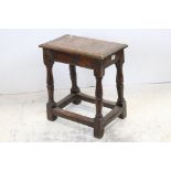 Late 17th century oak joint stool, the rectangular top on turned tapered legs and stretchers,