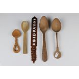 Three carved treen spoons together with an Olive wood letter opener.