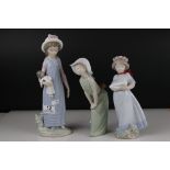 Three Lladro figures to include Girl holding chicken, Girl looking coy and Girl holding doll.