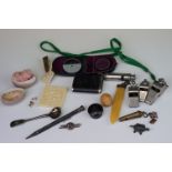 A box of mixed collectables to include whistles, eye glass, lighter and a book marker.