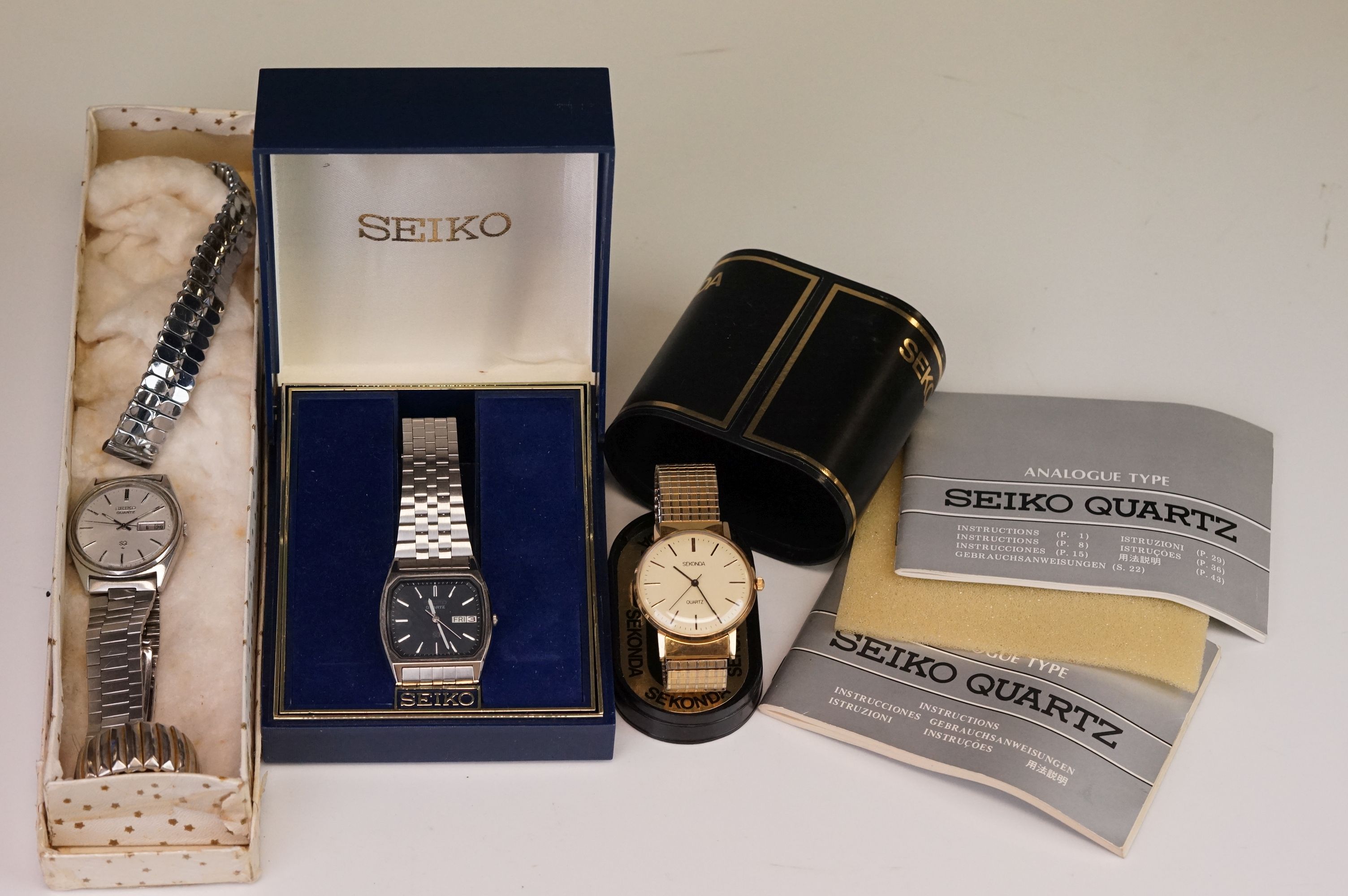 A boxed Seiko SQ gents day / date quartz wristwatch together with another Seiko and a Sekonda.