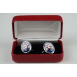 Cased pair of silver and enamel cufflinks depicting sailing ships at sea