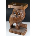 A carved wooden pot stand in the form of an owl, stands approx 49cm in height.