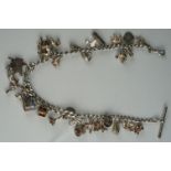 A vintage sterling silver charm bracelet with good quantity of charms.