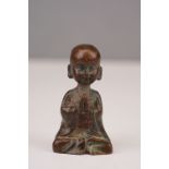 Bronze figure of a Buddha at prayer