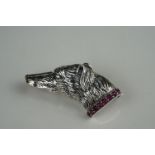 Unusual silver dog brooch, on ruby platform
