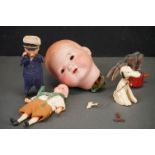 A collection of antique toys to include a clockwork seaman and a German bisque dolls head.