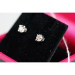 Pair of 14ct white gold diamond stud earrings of 65 points