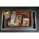 Three oriental trays with dragon decoration together with two soapstone bookends and a tile.