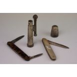 Two collectors pen knives, one with a silver blade, together with a trench lighter & thimble