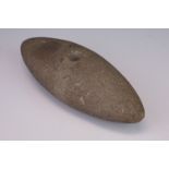 A carved stone tool head, possibly Native American.