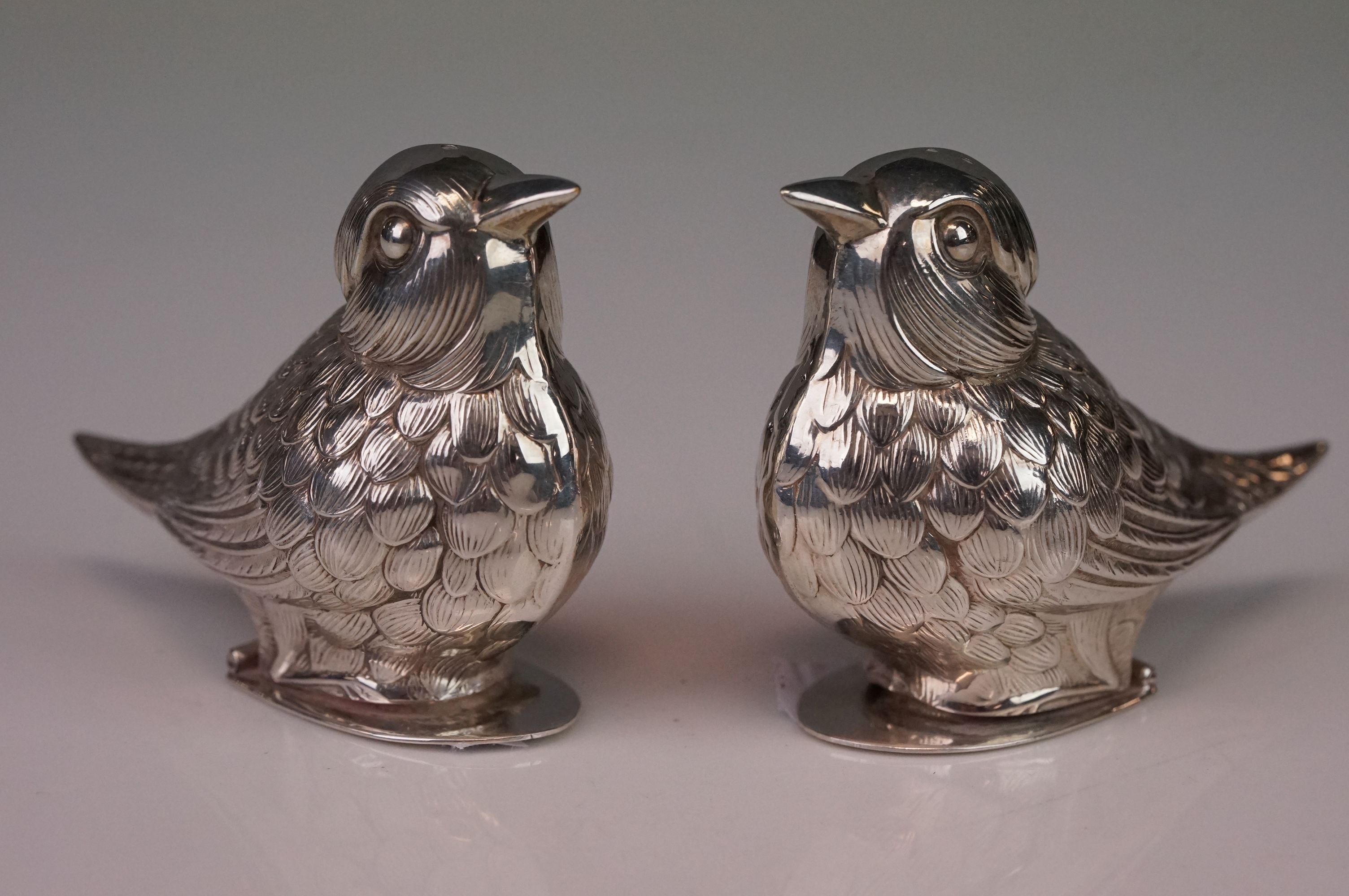 Pair of white metal bird condiment shakers