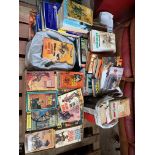 A mixed collection of books to include vintage western paperbacks and road atlases.