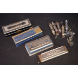 A collection of five vintage whistles to include police examples together with four harmonicas.