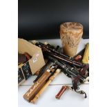 A large collection of recorders together with a drum and a flute.