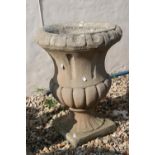 A reconstituted stone garden urn, stands approx 56cm in height.