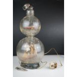 Ships in a bottle style Double gourd glass lamp with model ship to each gourd, 43 cm tall.