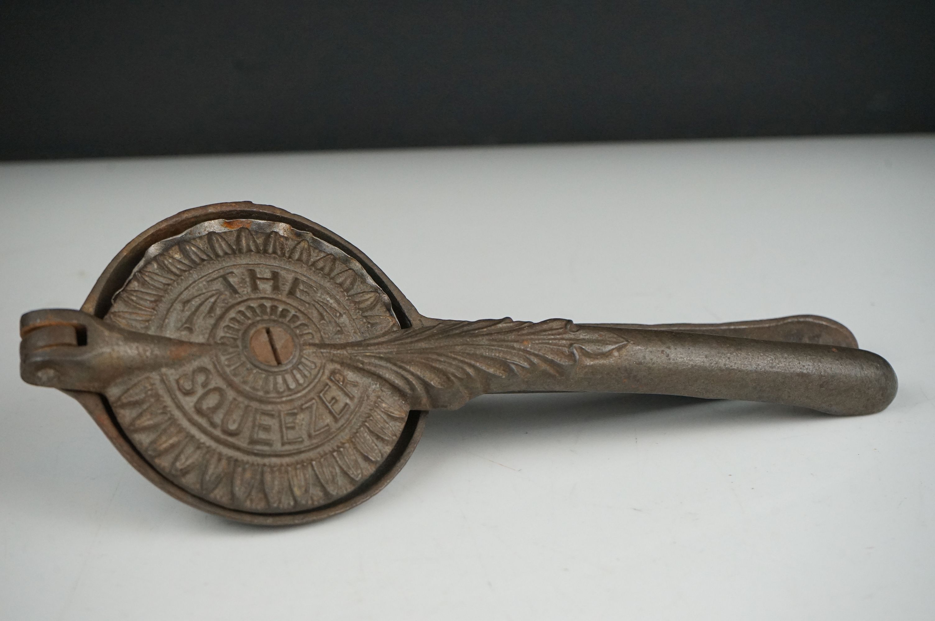 An early 20th century cast iron Lemon Squeezer with insert.