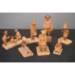 Group of wooden carved figures of tribal people at work