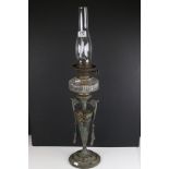 An antique oil lamp with marble base and original chimney.