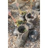 Four reconstituted stone planters in the form of boots together with a garden ornament in the form
