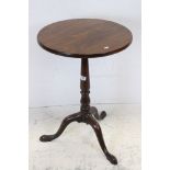George III Mahogany Circular Lamp Table raised on turned column support and three splay legs,