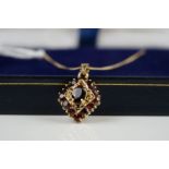 9ct yellow gold garnet pendant necklace, on a gold chain