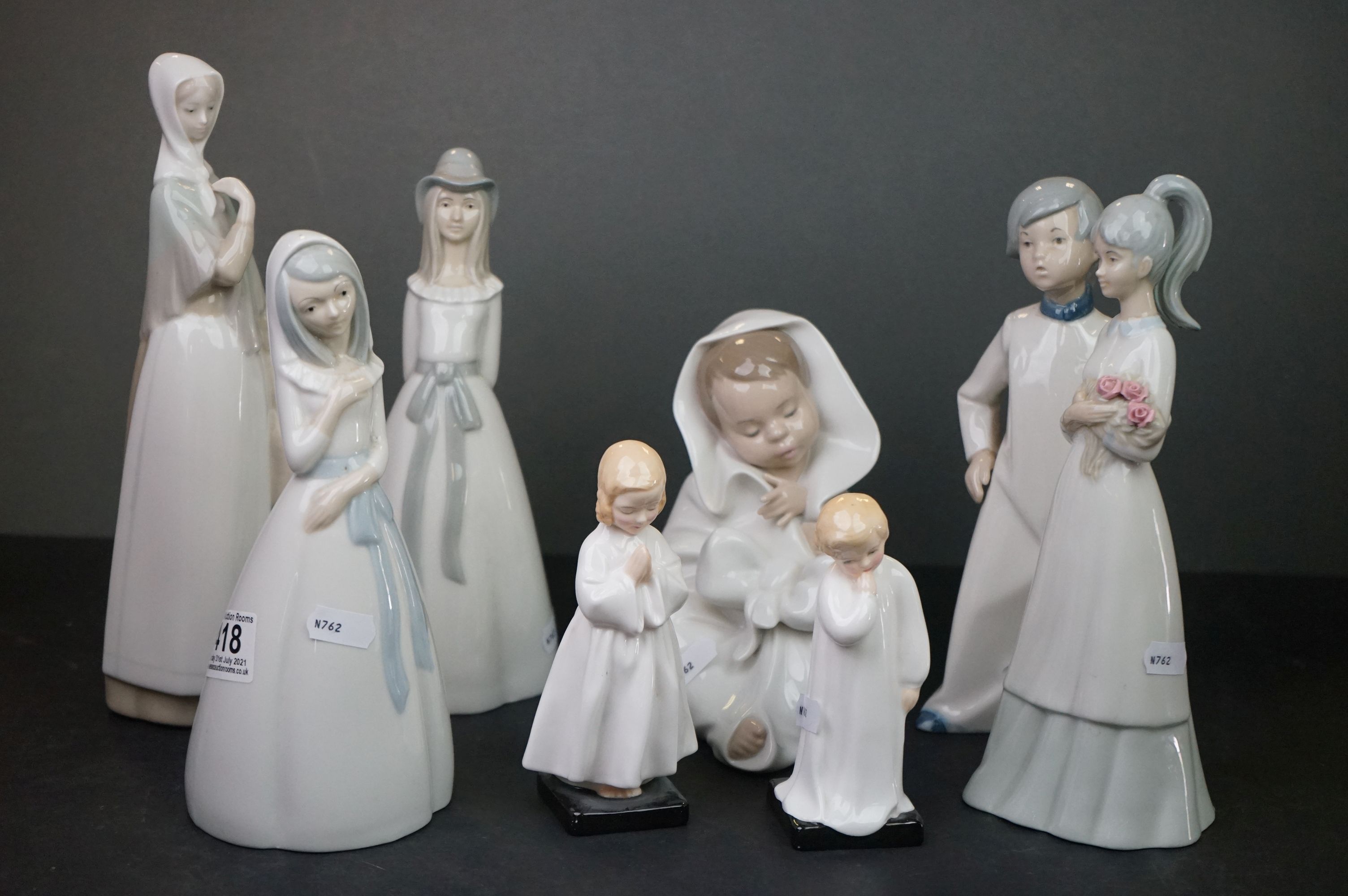 Nao Figure of a Young Child wrapped in a Blanket together with Five Spanish Lladro style Figures