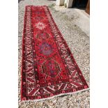 Large rich red ground, hand woven, persian runner, star burst medallion design, approx. 417cm x