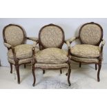 Set of Three French Fauteuil style Elbow Chairs, the oval backs with floral carved cresting, with