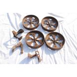 A group of antique cast iron wheels together with cast iron shoe lasts.