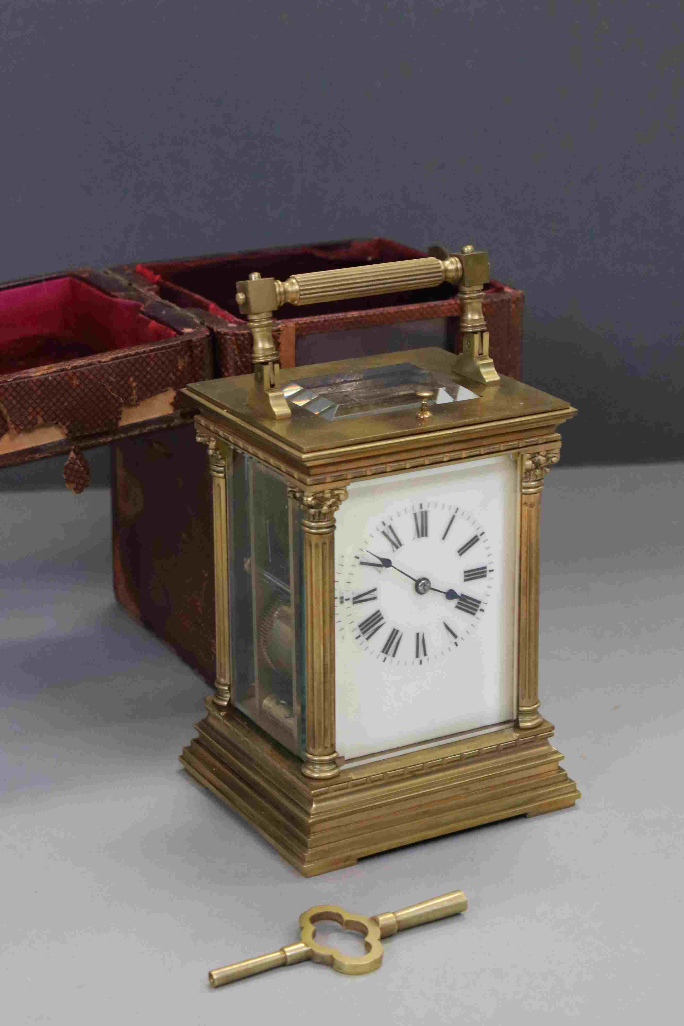 A large French brass cased repeater carriage clock with enamel dial and original travel case.