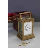 A large French brass cased repeater carriage clock with enamel dial and original travel case.