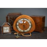 A collection of three wooden cased chiming mantle clocks together with a Smiths desk clock.