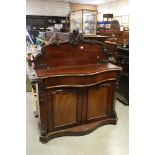 Victorian Chiffonier with carved shaped back, serpentine top over a frieze drawer and two cupboard