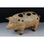 A large cast iron painted pig moneybox, approx 43cm in length.