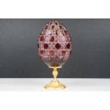Russian Faberge style wheel cut ruby red Egg mounted on Ormolu gilt stand decorated with floral