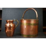 A copper log bucket with brass banding together with a copper jug.