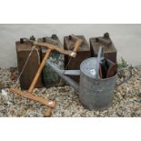 A collection of four vintage fuel cans together with a galvanised watering can and a vintage