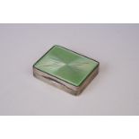 A vintage Art Deco continental silver lipstick compact with green enamel decoration.