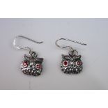 Pair of silver owl earrings, with ruby eyes