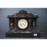 A large French slate mantle clock with marble embellishments.