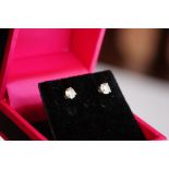 Pair of 14ct white gold diamond stud earrings of 65 points