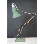 A vintage green angle poise desk lamp.