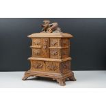 Black Forest style Carved Wooden Jewellery Box, the hinged lid carved with a bird opening to five