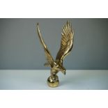 A large heavy polished brass eagle, measures approx 26cm in height.