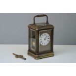 An antique brass cased carriage clock with repeater, complete with case and key.