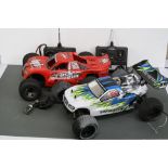 A HPI Racing Rush Evo 2WD stadium truck nitro 1/10 together with a Thunder Tiger Tomahawk ST 1/10