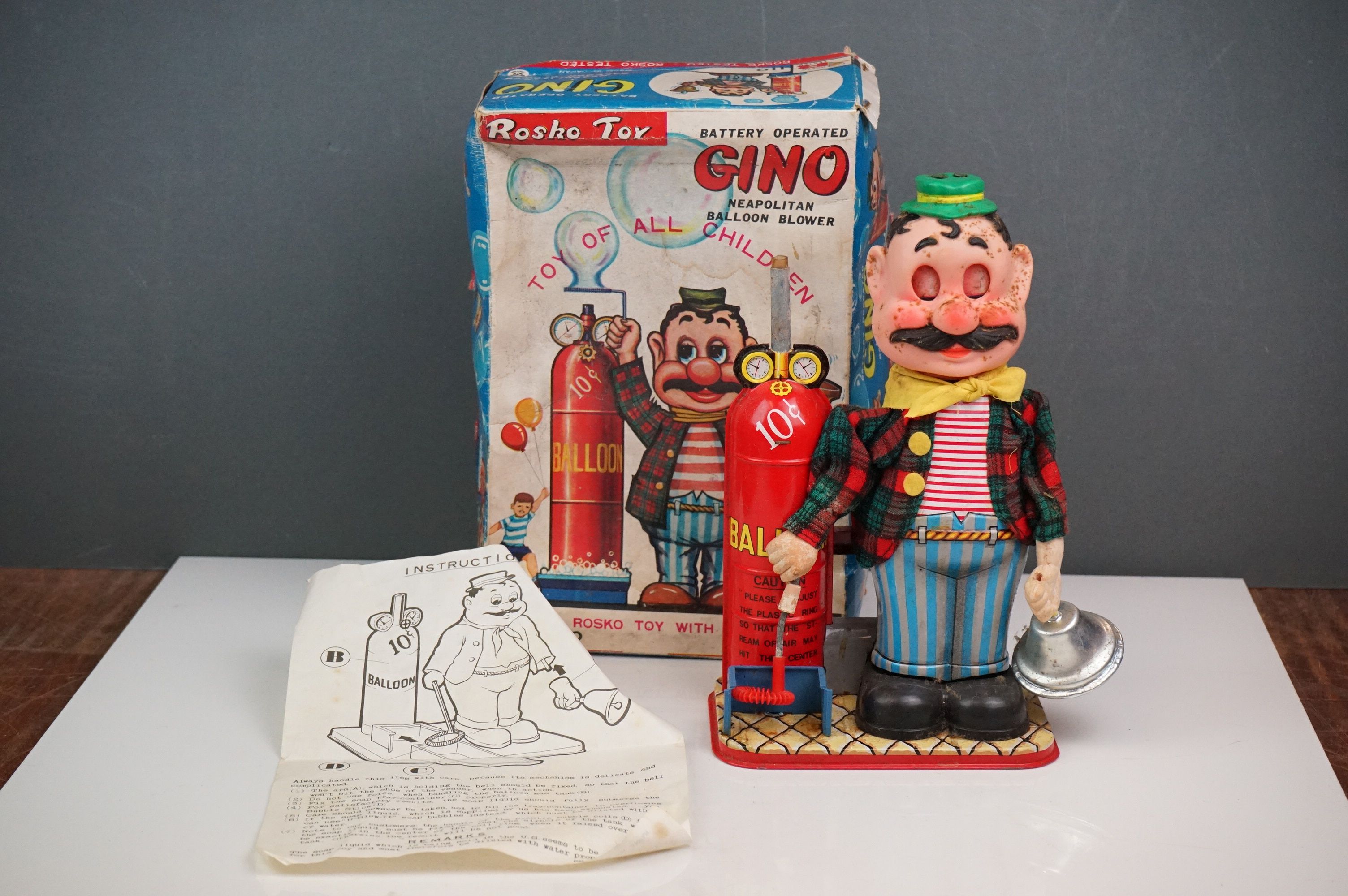 A vintage battery operated GINO the Neapolitan balloon blowers by Rosko Toys, in original box.